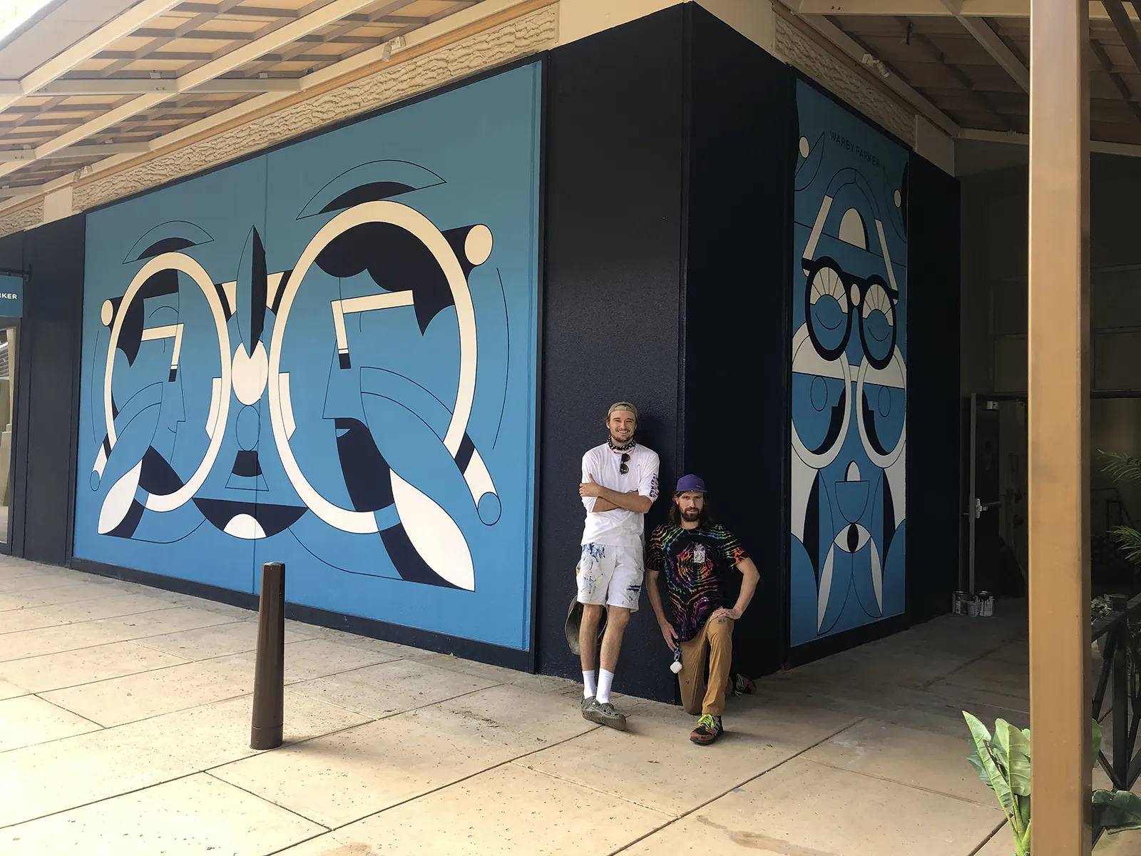 Creighton in front of Warby Parker mural