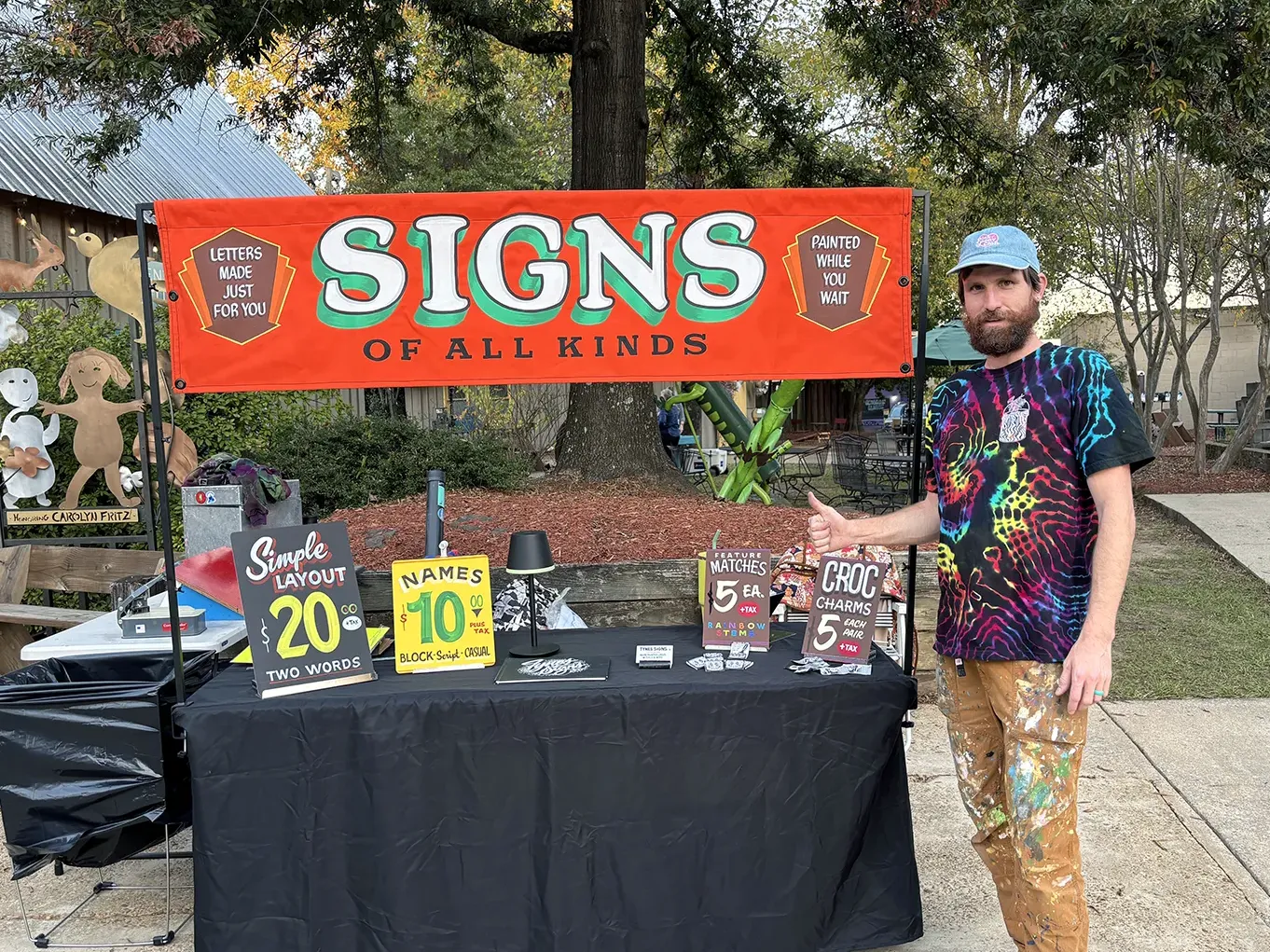 Creighton Tynes in front of orange SIGNS banner
