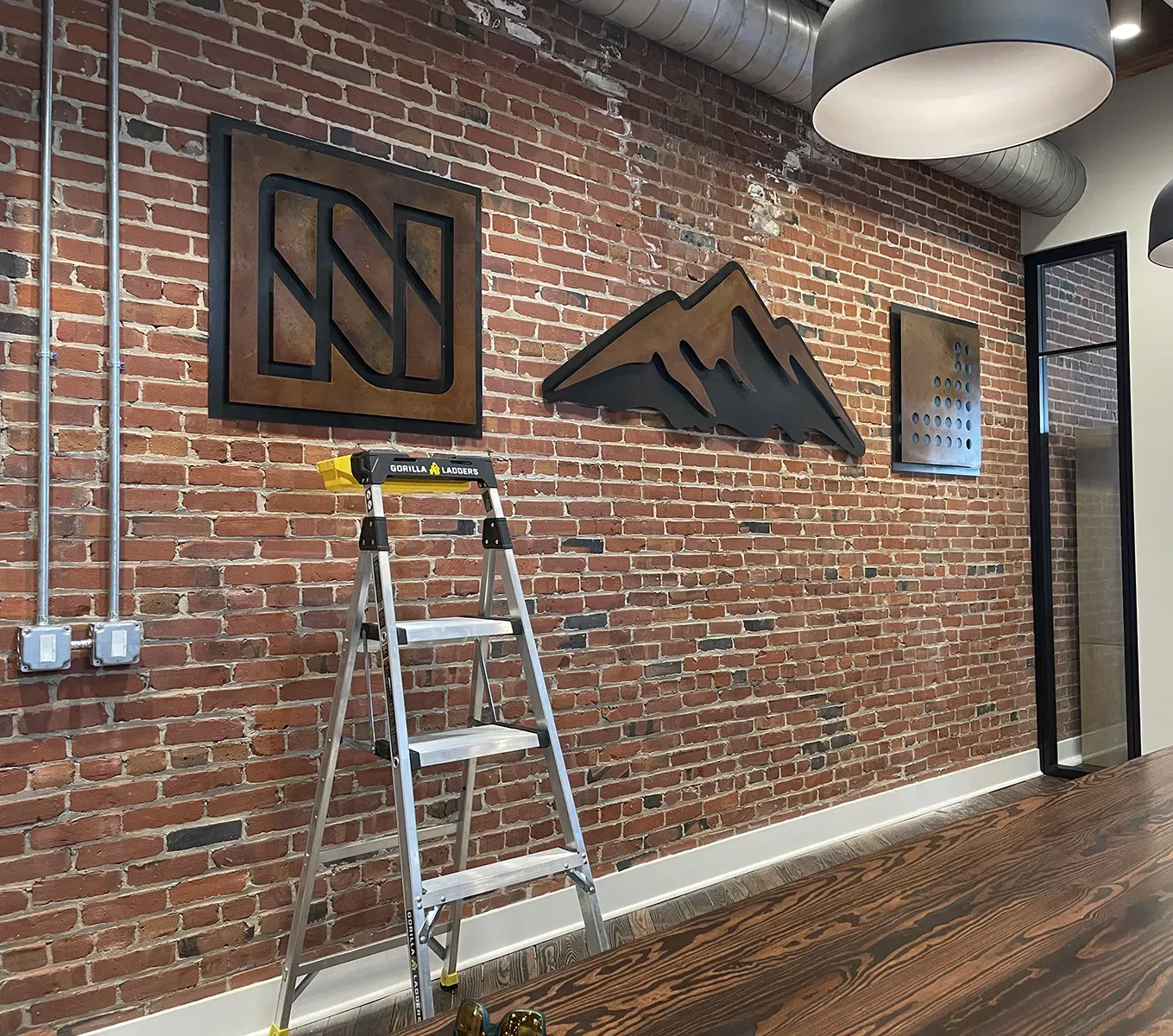 fabricated sign - logo signs installed in office space - Birmingham Alabama - 2nd Ave N - metal patina